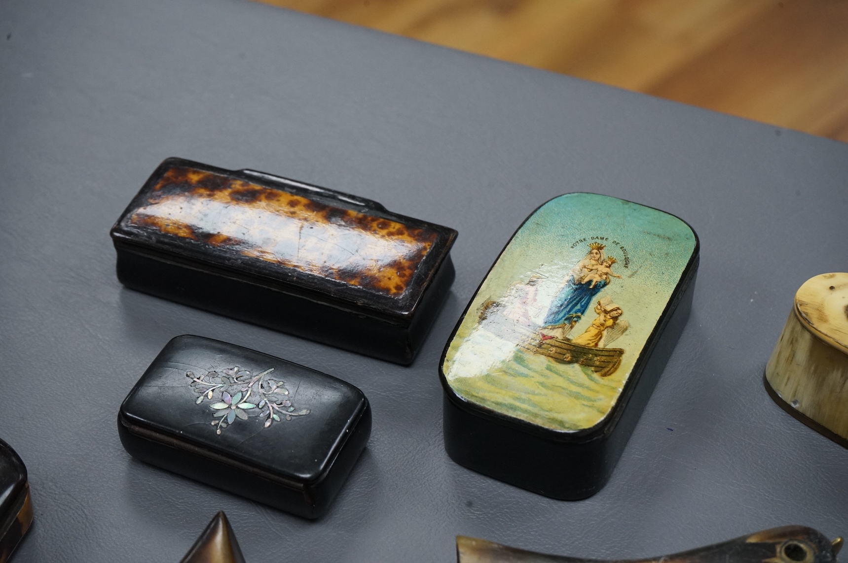 Eleven assorted horn, lacquered and ebony snuff boxes, the majority 19th century, largest 8.5cm long.